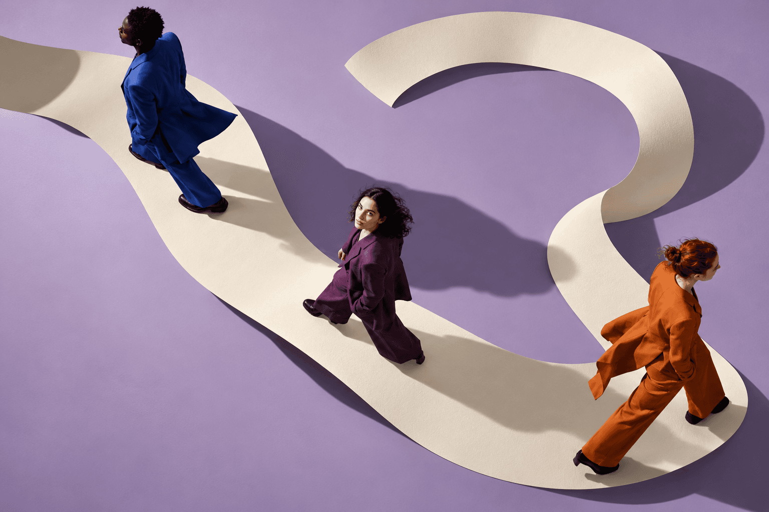 Surreal conceptual scene of people moving along a winding ribbon, a metaphor for the human experience of change.